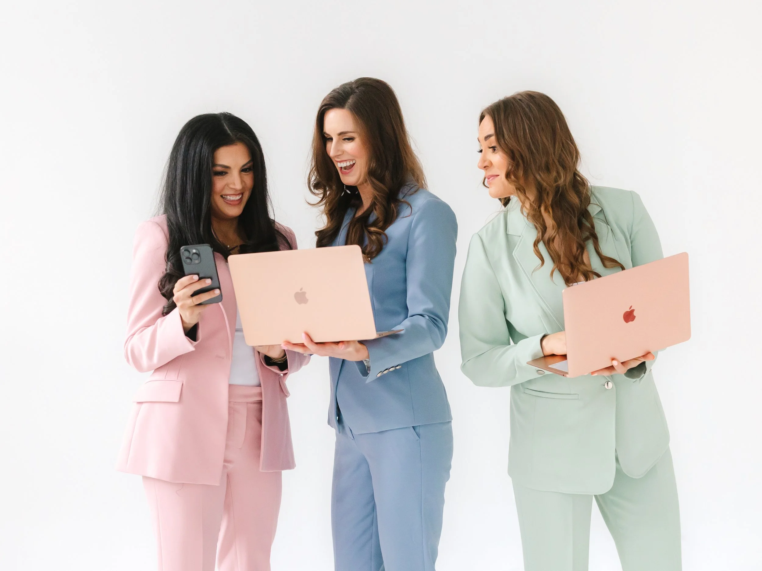 Virtual Assistants in pastel suits holding laptops and a phone talking about how much virtual assistance costs